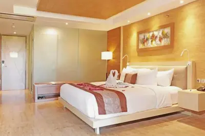a bedroom with a large white bed in a room at Viorel 1 BR Whirlpool Suite Room in Seminyak