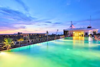 a pool of water in front of a building at Viorel 1 BR Whirlpool Suite Room in Seminyak