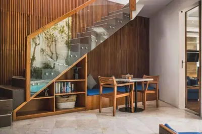 a dining room with a table and a staircase at Luxury 2 BR Villa with Private Pool & Bathtub in Seminyak