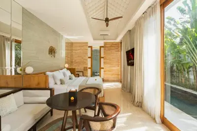a living room with a bed and a table at Entire 1 BR Villa With Private Pool in Seminyak