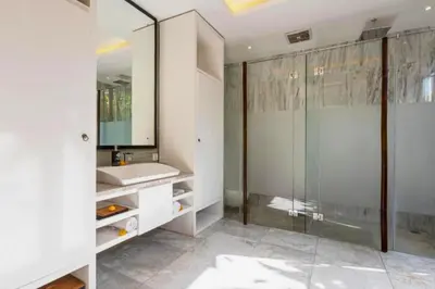 a bathroom with a glass shower and a sink at Entire 1 BR Villa With Private Pool in Seminyak