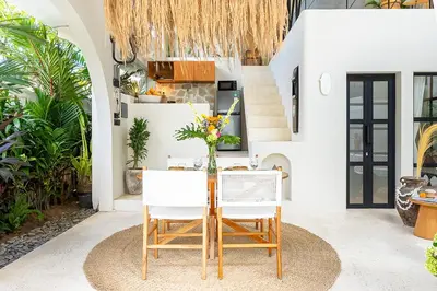 a dining room with a table and chairs at Casa Toledo 1 Bedroom Seminyak - Kerobokan in Seminyak