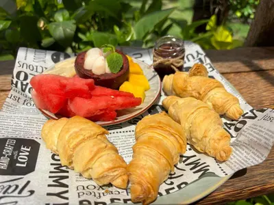 a plate of pastries and fruit on a table at Villa Divna in Nusa Dua