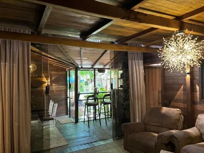 a living room with a couch and a chandelier at Villa Divna in Nusa Dua