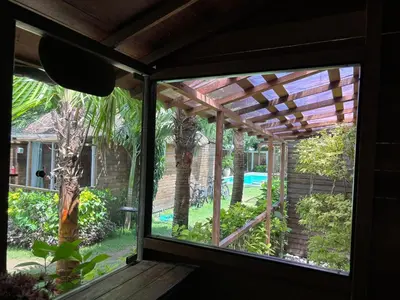 a window view of a patio with a pergola at Villa Divna in Nusa Dua