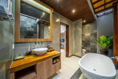 a bathroom with a sink and a bath tub at Villa MD 2 Stylish 3 BR w/ Sunny Pool at Prime Eat Street in Seminyak