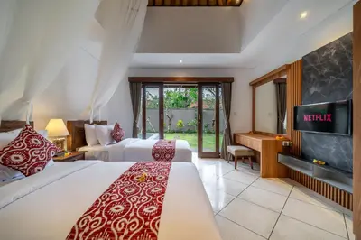 a hotel room with two beds and a flat screen tv at Villa MD 2 Stylish 3 BR w/ Sunny Pool at Prime Eat Street in Seminyak