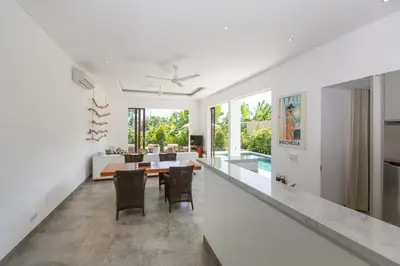 a kitchen and dining room with a table and chairs at Gajah Villas Bali by Nagisa Bali in Seminyak