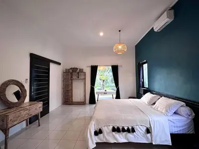 a bedroom with a large bed with a green wall at 2 BR Villa Rhapsody - 5 Mins to Seminyak/Umalas in Seminyak