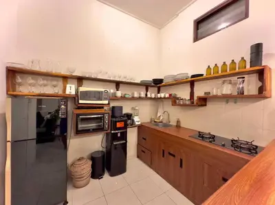a kitchen with wooden cabinets and a counter top at 2 BR Villa Rhapsody - 5 Mins to Seminyak/Umalas in Seminyak