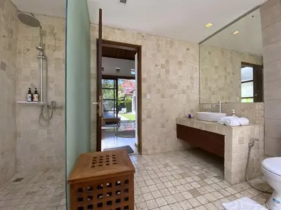 a bathroom with a tub and a sink and a toilet at Spacious Villa in Petitenget Top Location in Seminyak