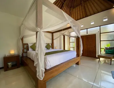 a bedroom with a large bed with a canopy at Spacious Villa in Petitenget Top Location in Seminyak