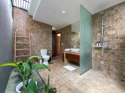 a bathroom with a tub and a toilet and a sink at Spacious Villa in Petitenget Top Location in Seminyak