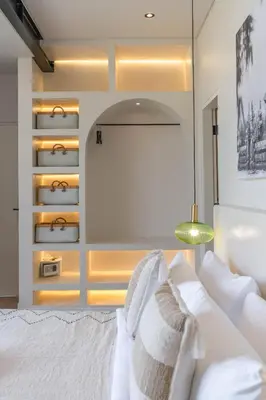 a bedroom with a bed with white pillows at Villa Maverick - Brand New Classy 4BR Villa in Canggu in Canggu