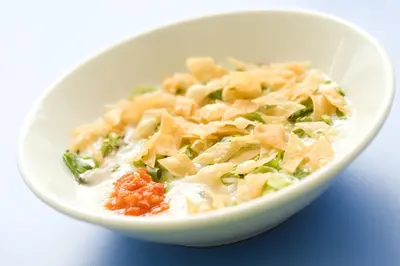 a white bowl of food with pasta and vegetables at Amaris Hotel Teuku Umar in Denpasar