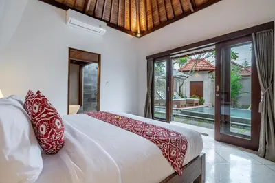a bedroom with a bed and a large window at Villa MD Tranquil 6BR Villa at Eat Street in Seminyak