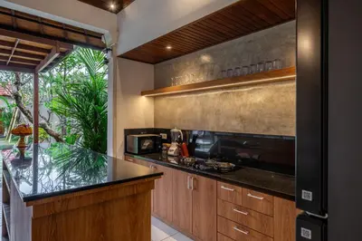 a kitchen with a black counter top and a counter sidx sidx sidx sidx at Villa MD Tranquil 6BR Villa at Eat Street in Seminyak