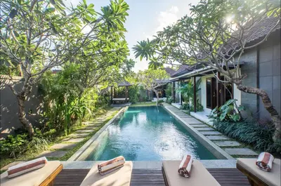 an infinity pool in the backyard of a villa at Villa MD Tranquil 6BR Villa at Eat Street in Seminyak