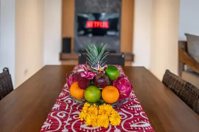 a table with a bowl of fruit on top of it at Villa MD Tranquil 6BR Villa at Eat Street in Seminyak
