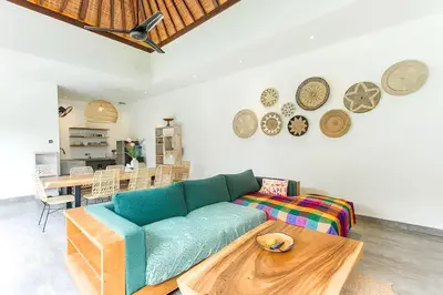 a living room with a blue couch and a table at Villa GrandLux Bali 2 Bed Villa Pool Big Garden in Seminyak