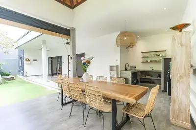 a dining room with a wooden table and chairs at Villa GrandLux Bali 2 Bed Villa Pool Big Garden in Seminyak