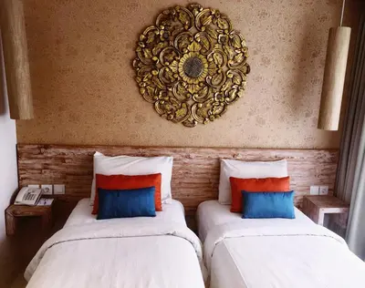 two beds sitting next to each other in a room at Destiny Boutique Hotel in Seminyak