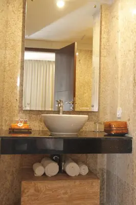 a bathroom with a sink and a mirror and towels at Destiny Boutique Hotel in Seminyak