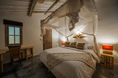 a bedroom with a large bed with a canopy at Villa Adagian - Magical 3BR Villa in Umalas in Canggu