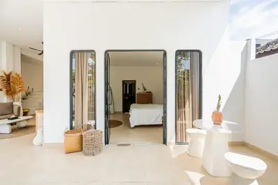 a white room with a mirror and a bedroom at Villa Arawan - Beautiful 3BR Villa in Kerobokan in Kerobokan