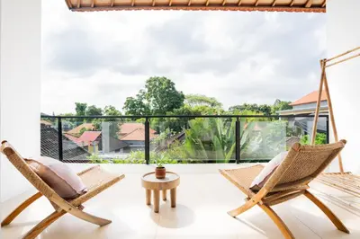 a room with two chairs and a large window at Villa Arawan - Beautiful 3BR Villa in Kerobokan in Kerobokan