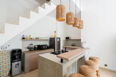 a kitchen with a counter and a stove top oven at Villa Arawan - Beautiful 3BR Villa in Kerobokan in Kerobokan