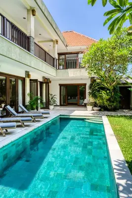 a swimming pool in front of a villa at Virginia villa 4BR 5min walk to beach with assistant villa and pick up from airport and security in Canggu