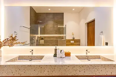 a bathroom with two sinks and a large mirror at Villa Marlex by Bukit Vista in Seminyak