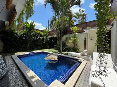 a swimming pool in the backyard of a house at Kubu D Kubu Villa - 3 Bedroom - Legian in Legian
