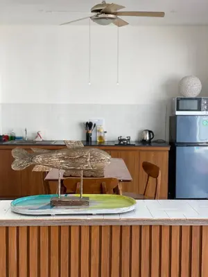 a surfboard sitting on top of a counter in a kitchen at 3 BR Chrysanthemum Villa nusadua in Nusa Dua