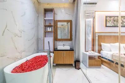 a bathroom with a tub and a bed and a sink at Villa Sun Lila by JB Villas in Seminyak