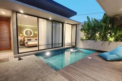 a swimming pool in the middle of a house at Akhila 1 - 1 BR modern tropical villa at the heart of Seminyak in Seminyak
