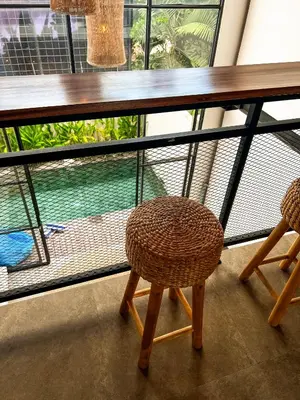a table and two chairs in front of a window at Tropical Loft Steps Away from the Beach! Hidden GEM! in Canggu