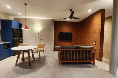 a living room with a table and a couch at Akhila 4 - 1 BR modern tropical villa at the heart of Seminyak in Seminyak