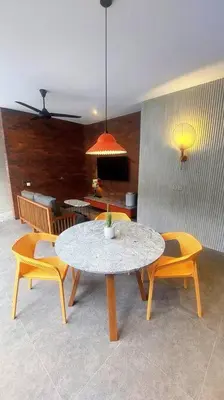 a dining room with a table and two chairs at Akhila 4 - 1 BR modern tropical villa at the heart of Seminyak in Seminyak