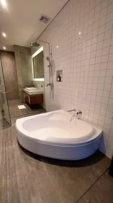a large white tub in a bathroom with a shower at Akhila 4 - 1 BR modern tropical villa at the heart of Seminyak in Seminyak