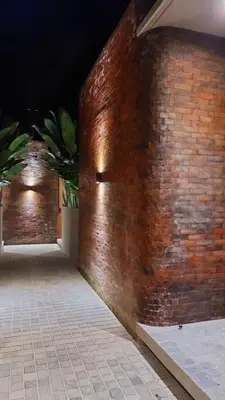 a brick wall with a door on the side of a building at Akhila 5 - 1 BR modern tropical villa at the heart of Seminyak in Seminyak