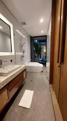 a bathroom with a shower and a sink and a tub at Akhila 5 - 1 BR modern tropical villa at the heart of Seminyak in Seminyak