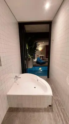 a bathroom with a white tub in a room at Akhila 5 - 1 BR modern tropical villa at the heart of Seminyak in Seminyak