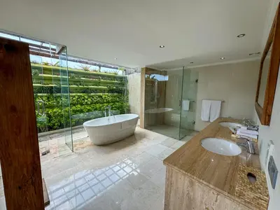 a large bathroom with a tub and a sink at Tranquil Classic Balinese Villa in Badung