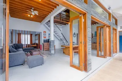 a living room with a couch and a staircase at Private 3 Bedroom Villas, 5 mnt to Beach Nusa Dua in Nusa Dua