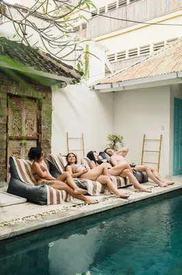 a group of naked women laying on beds next to a swimming pool at Seminyak Villa, Pool, 2 min to Double Six Beach in Seminyak