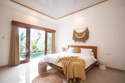 a bedroom with a bed and a large window at Sundaze 1 - Private Vila in Canggu with Huge Pool in Kerobokan