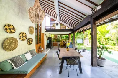 a dining room with a couch and a table at Anggana Villa 2 in Canggu