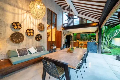 a living room with a wooden table and a couch at Anggana Villa 2 in Canggu